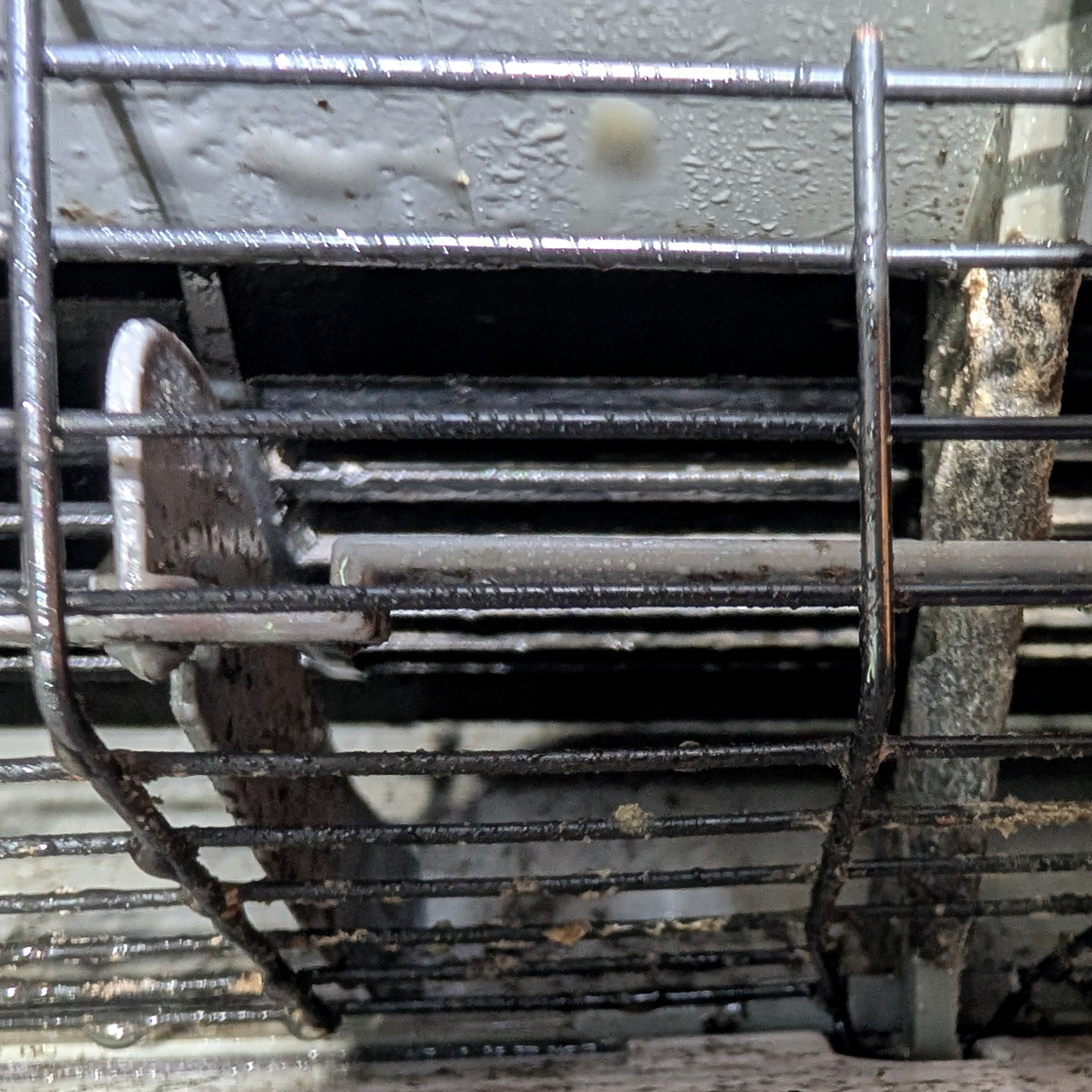 Close-up view of a dirty air conditioning unit before cleaning